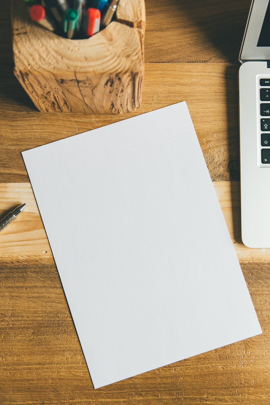 writer sitting at wooden desk with notebook